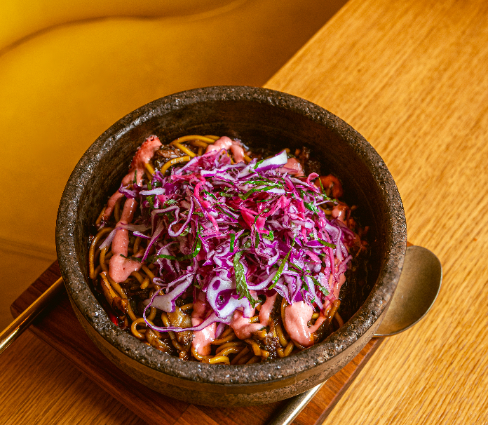 Fresh shrimp sashimi on ice with lime and flower garnish.