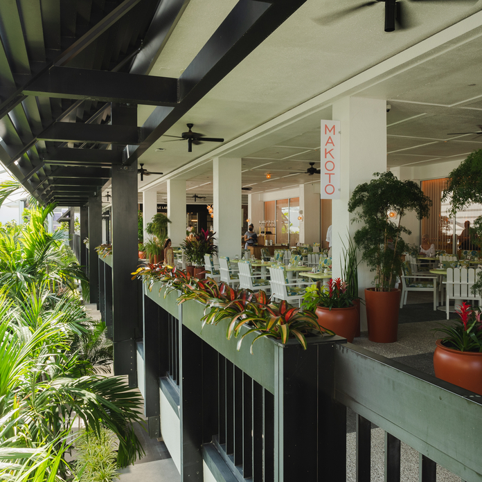 A vibrant bowl of ceviche with octopus tentacles, diced yellow squash, red and green vegetables, and bright red caviar.