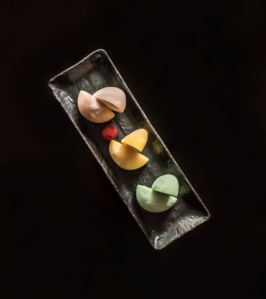 Table view from above of pink, yellow and green mochi ice cream